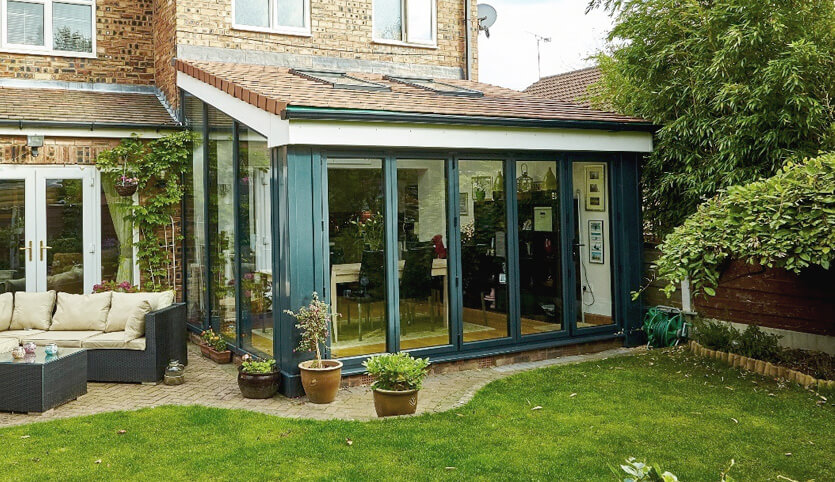 Grey lean to conservatory with a tiled roof