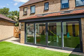 Black aluminium bifold doors installed in an extension